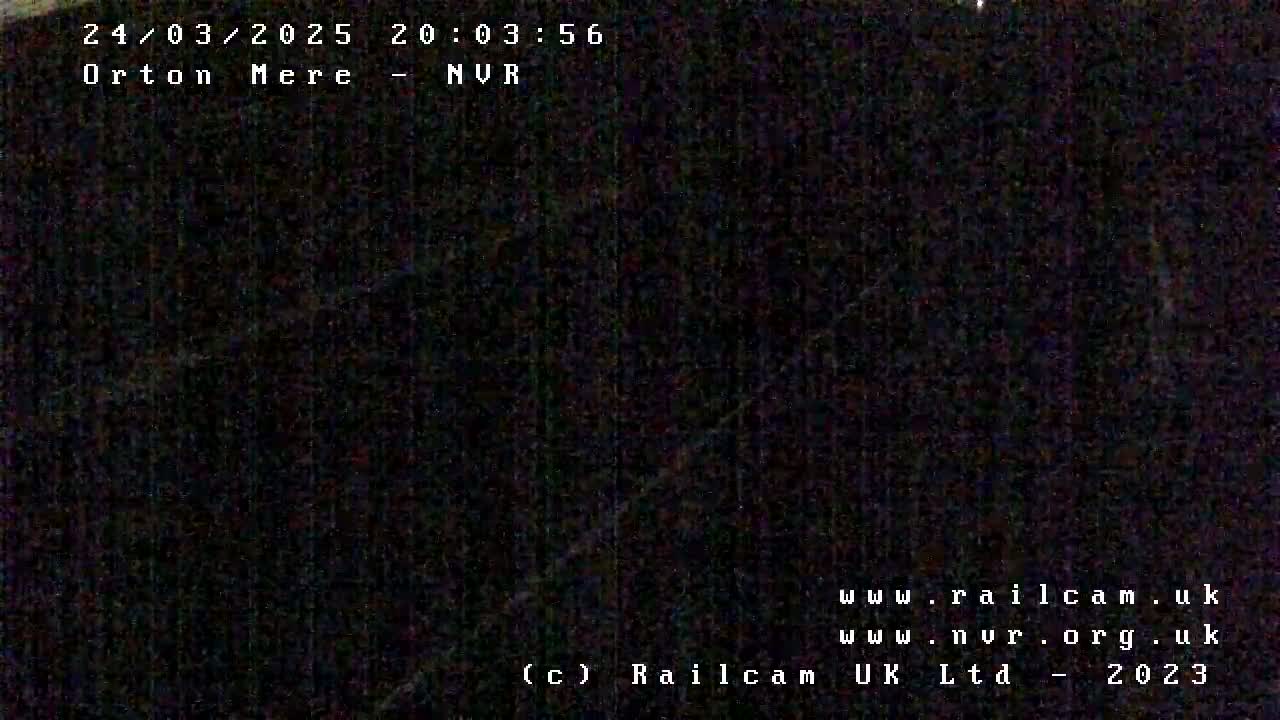 A very dark, nighttime image shows a nearly indiscernible scene.