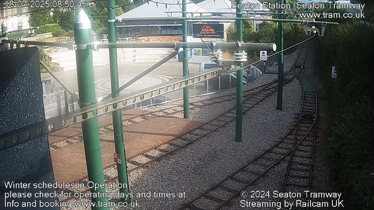 A high-angle view of a tram station's train tracks and turning area on a sunny day.