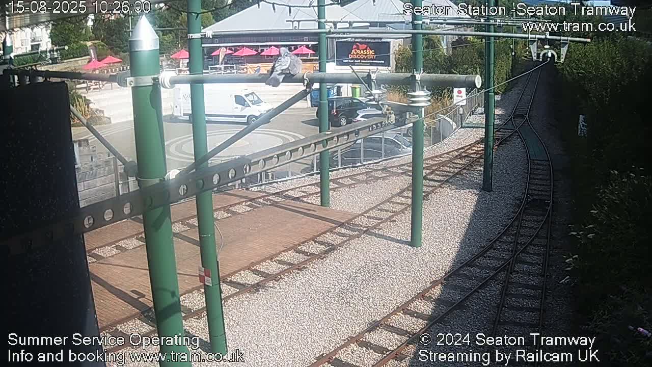 A high-angle view of a tram station's train tracks and turning area on a sunny day.