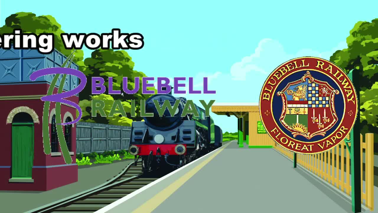 A steam train is stopped at a railway station on a sunny day, with a water tower and green trees visible in the background.