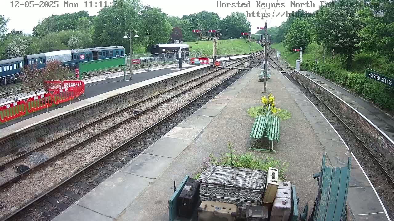 A train sits at a station platform on an overcast day.
