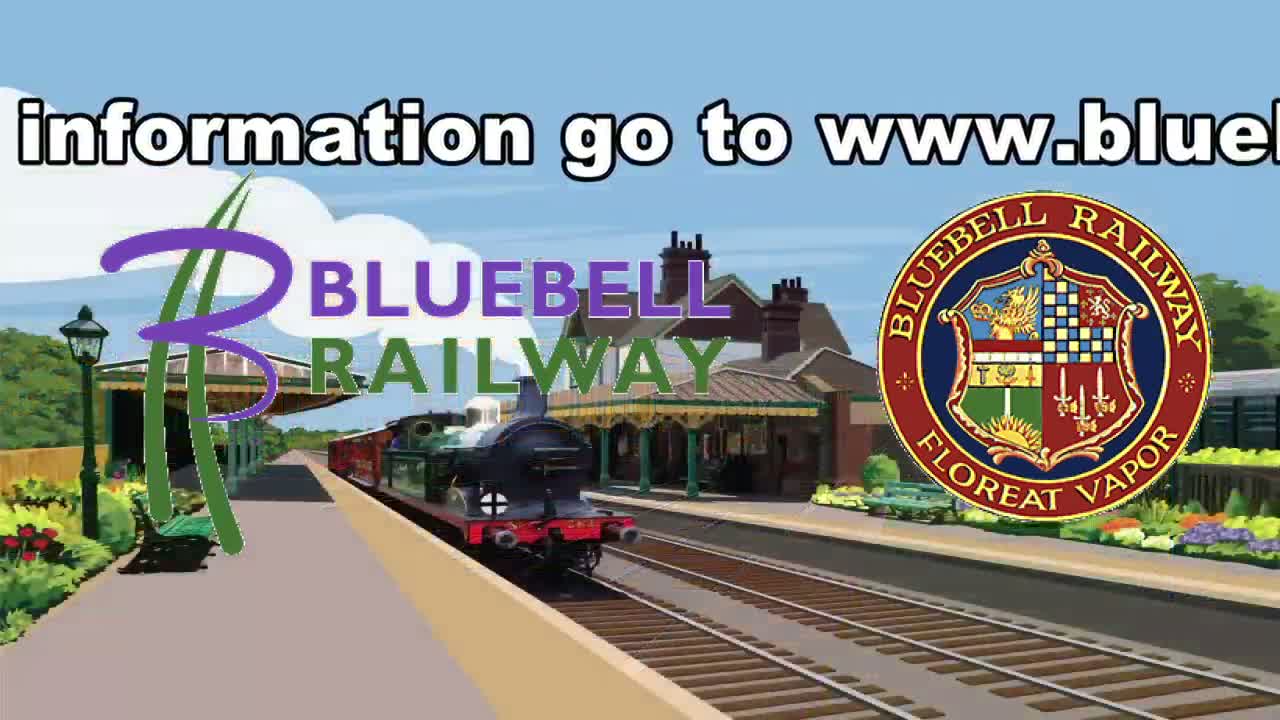 A steam train pulls into a brightly lit train station on a sunny day.