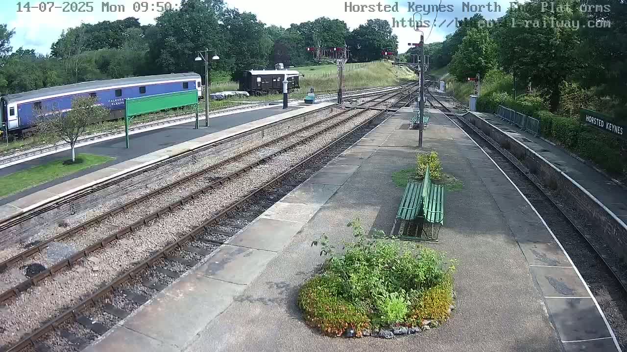 A train is parked at a railway station on a sunny day.