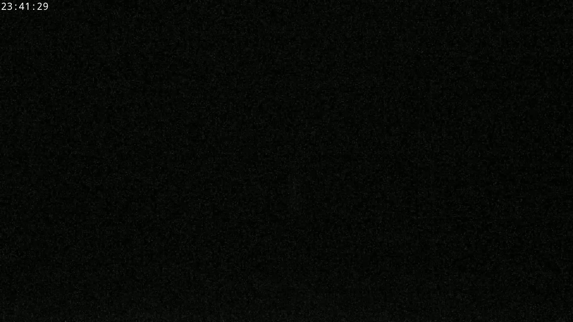 The image shows a completely dark, grainy surface.