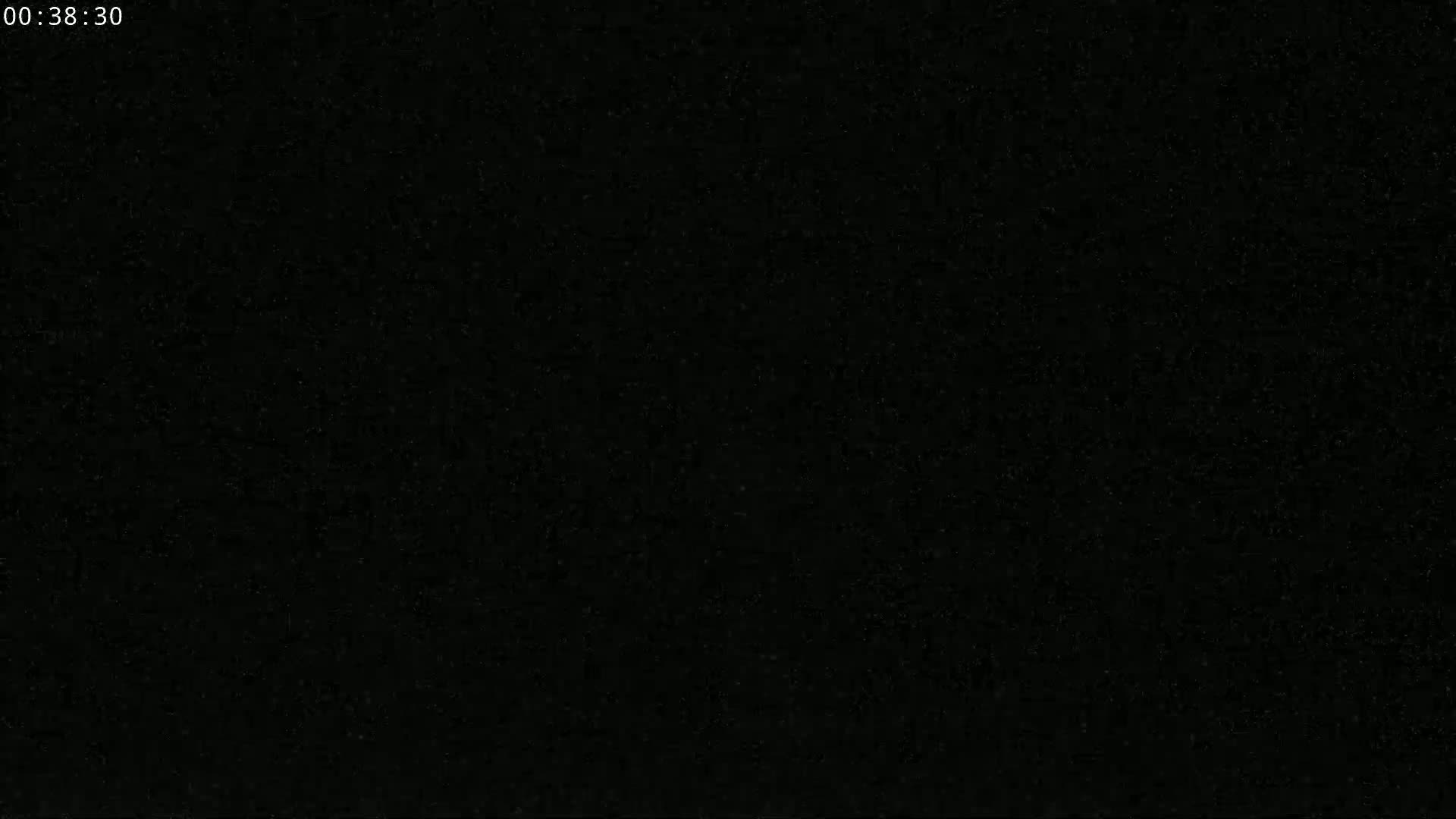 The image shows a completely black screen with subtle grainy texture.