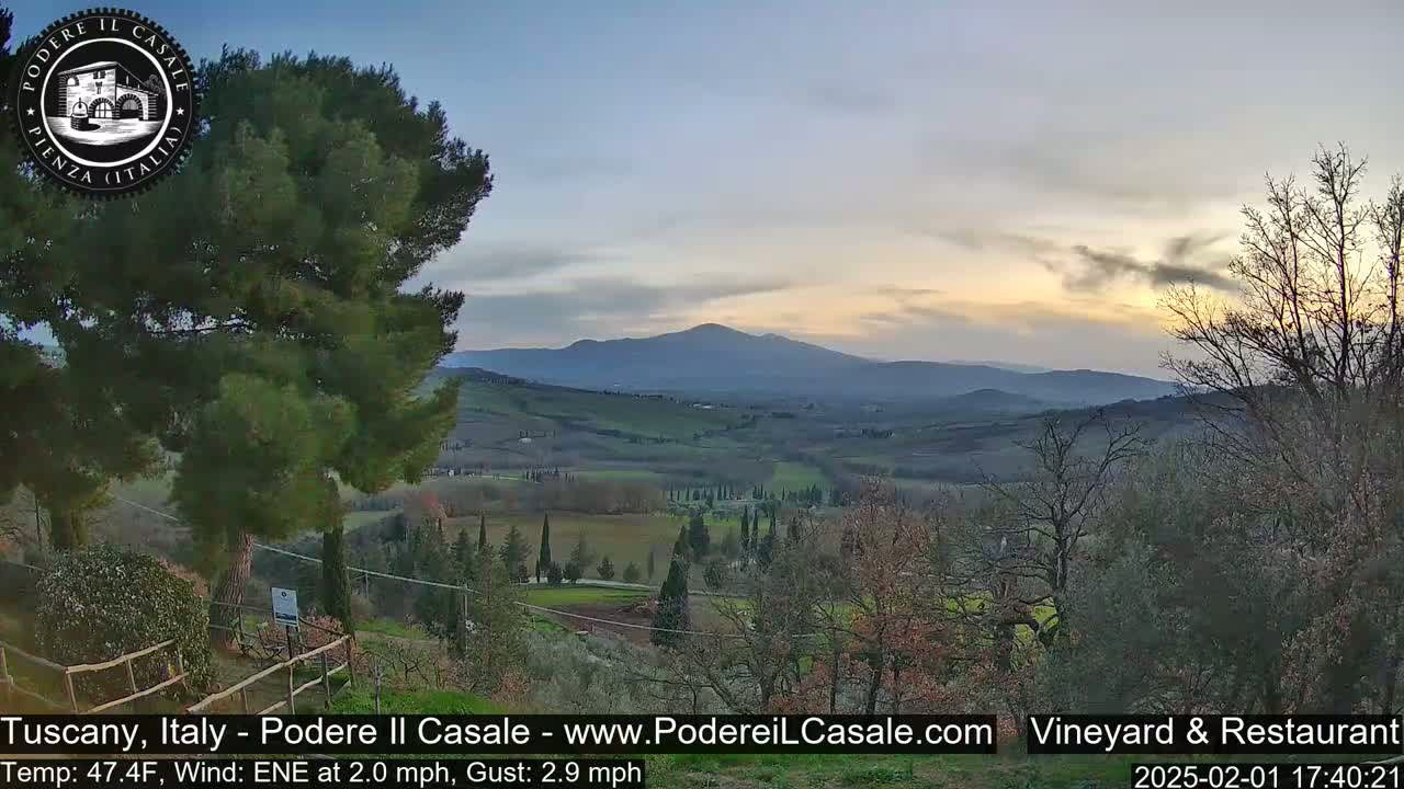 A tranquil sunset over rolling Tuscan hills, with a gentle east-northeast wind.
