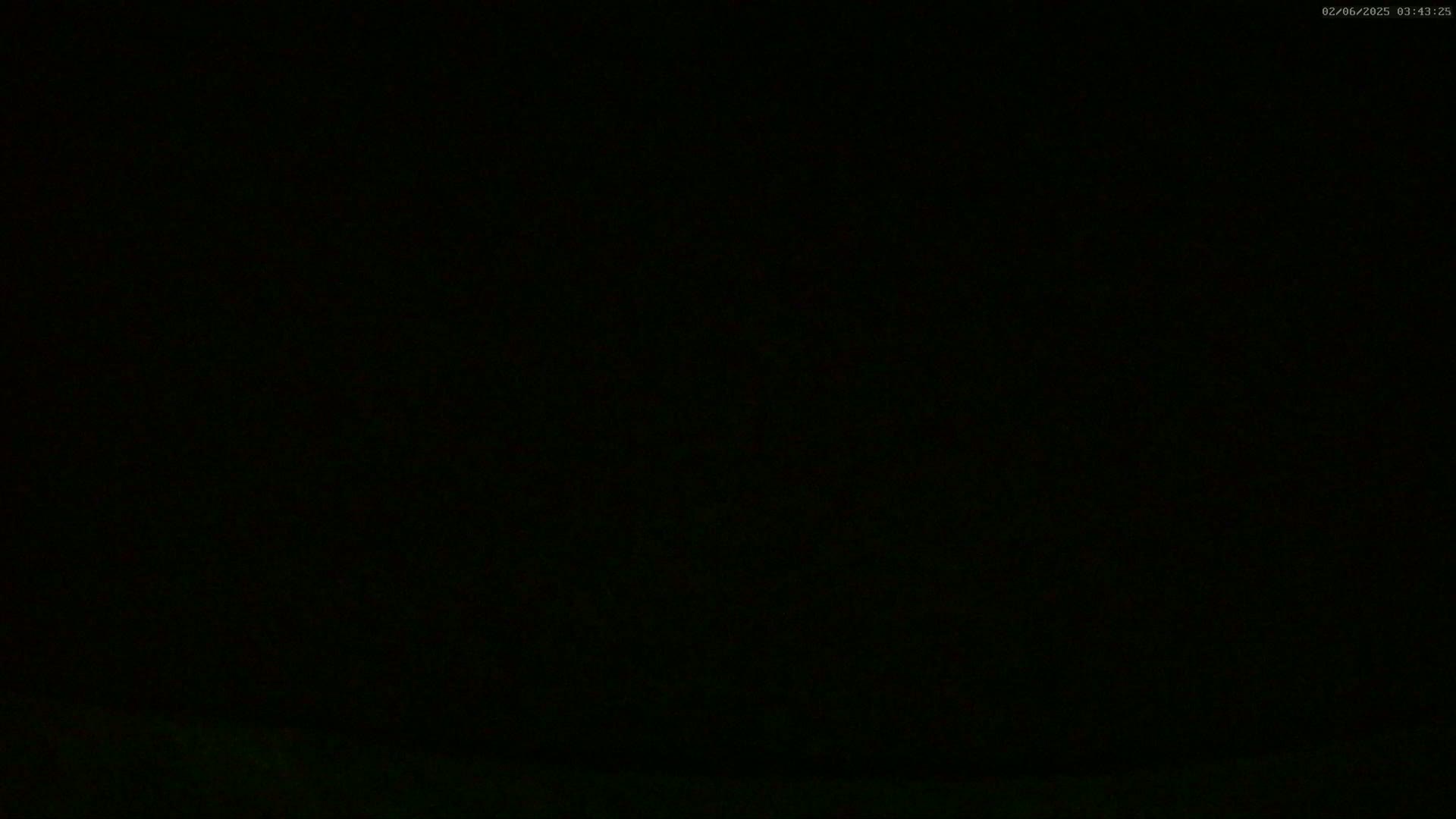 The image is almost entirely black, possibly depicting nighttime conditions.