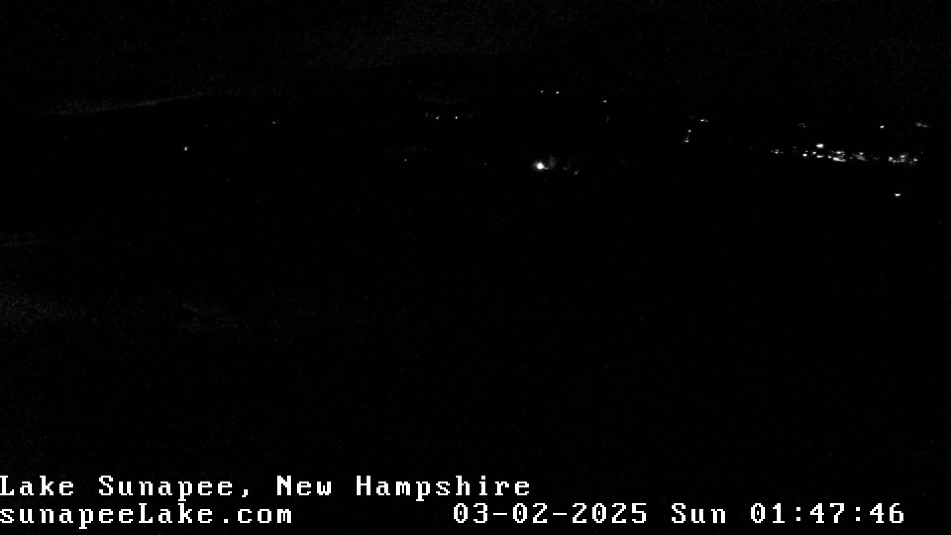 A nighttime, long-range view of a dimly lit shoreline.