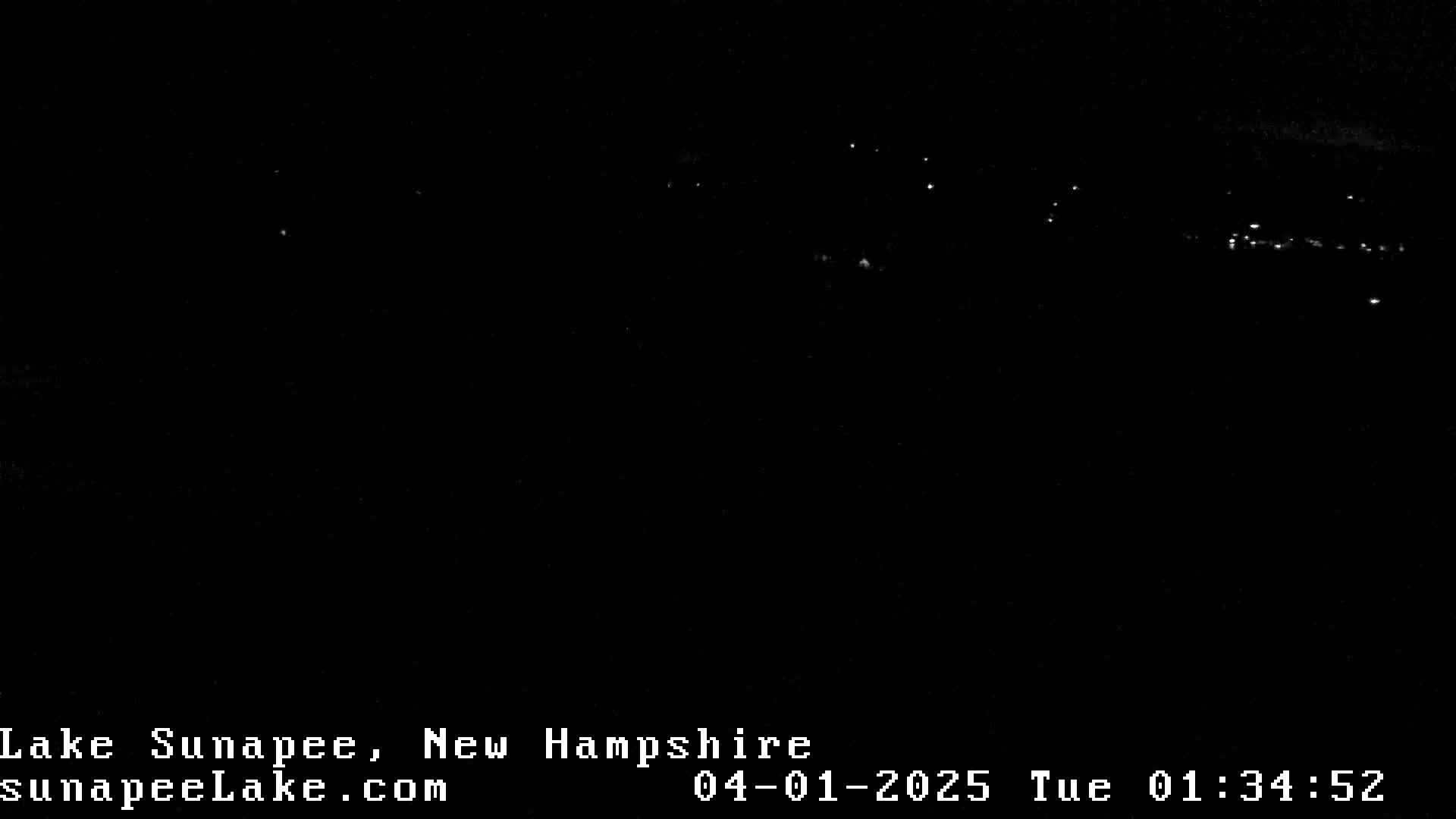 A nighttime long shot shows a distant line of lights across a dark landscape.