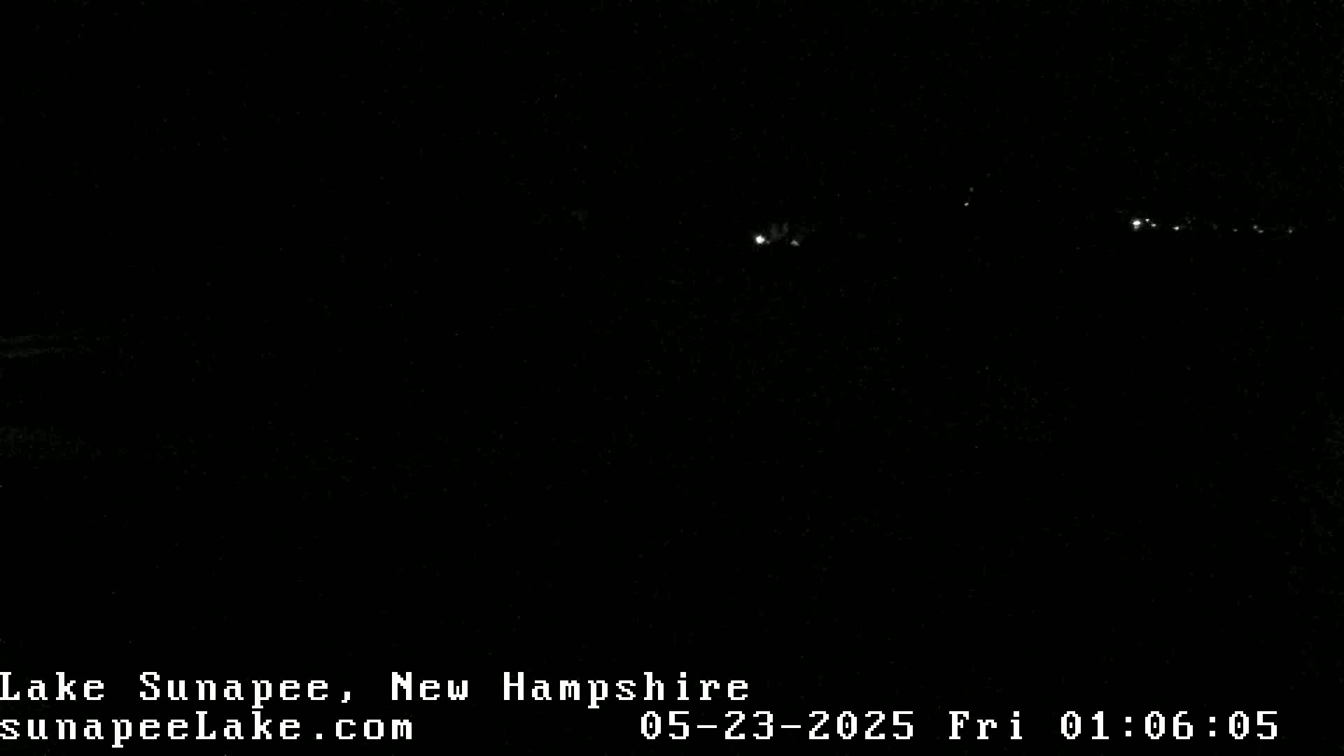 A nighttime long shot shows a faint line of distant lights across a dark, apparently clear sky.