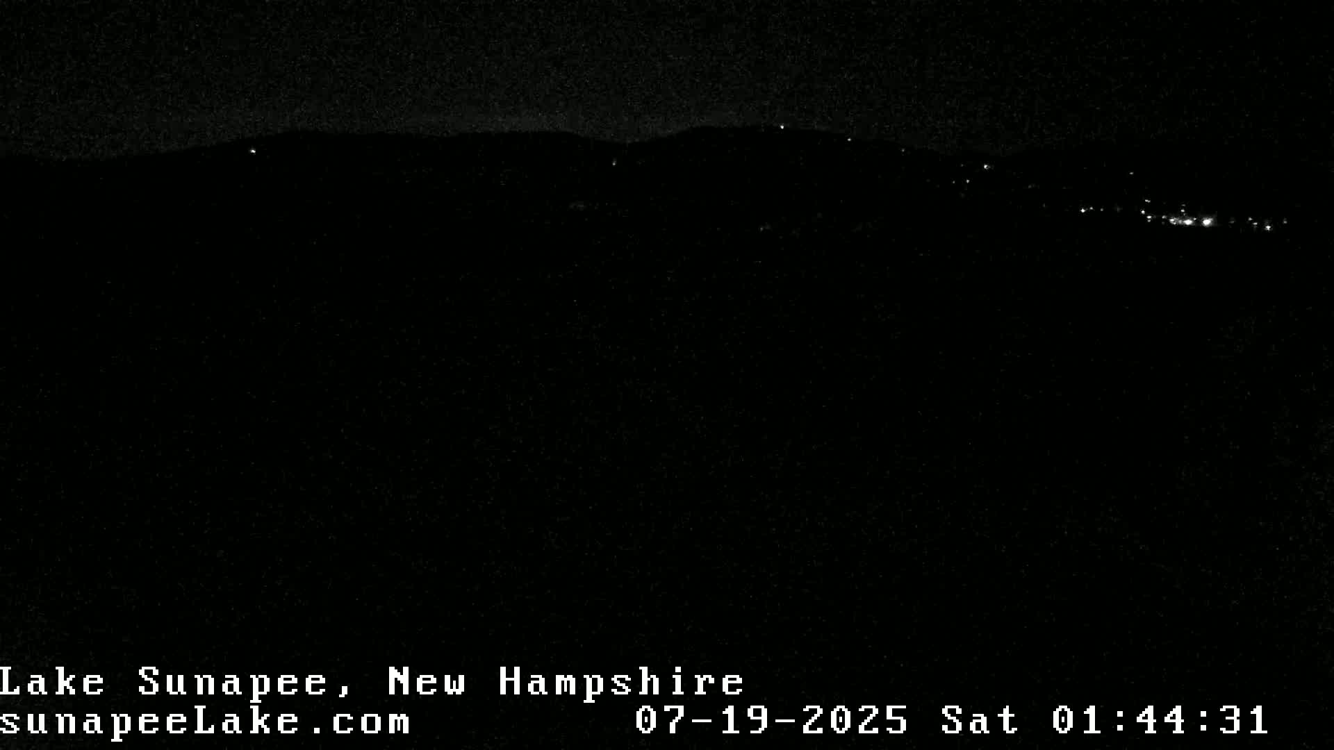 A nighttime view of a distant, dimly lit landscape.