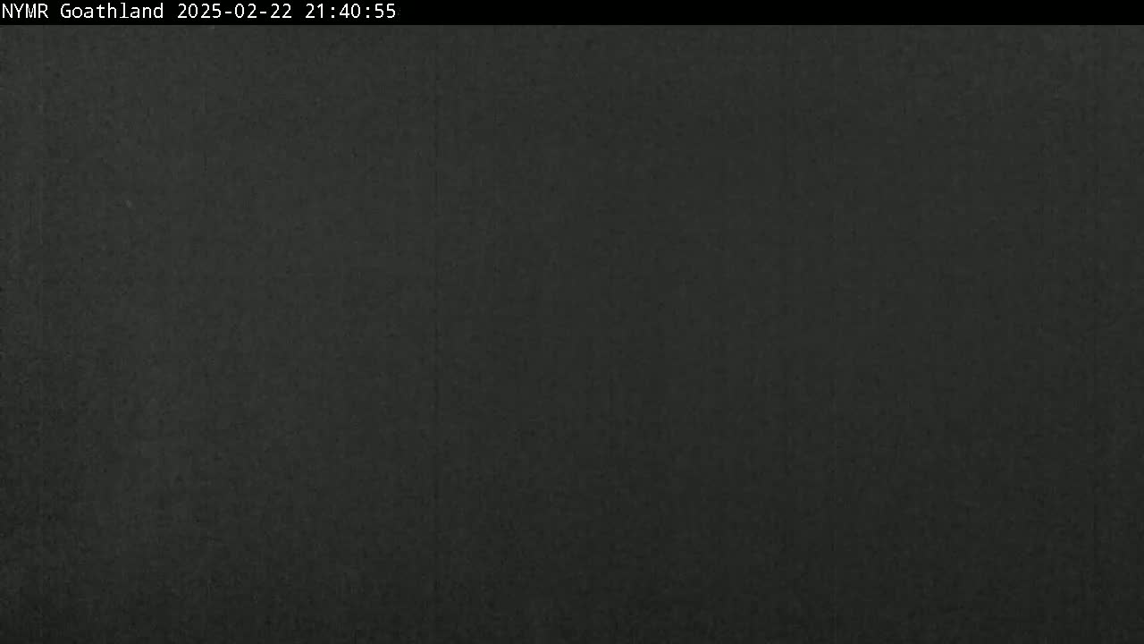 A dark, uniformly colored image shows a solid dark-gray or black surface.