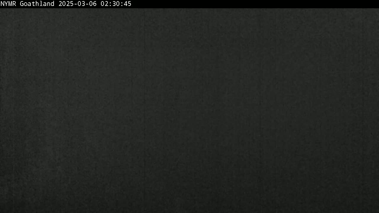 A dark gray or black image with a slightly textured surface is shown.