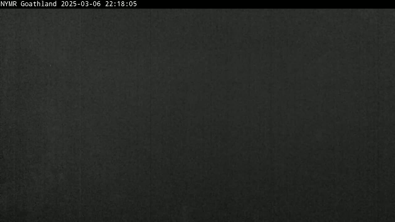 The image shows a dark gray or black textured surface at night.