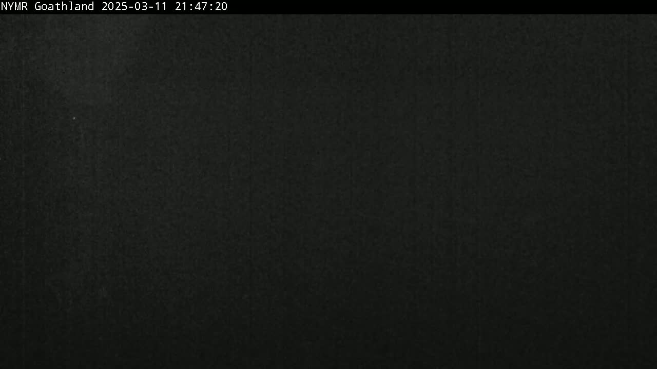 A dark, grainy image shows a mostly black, nighttime scene.