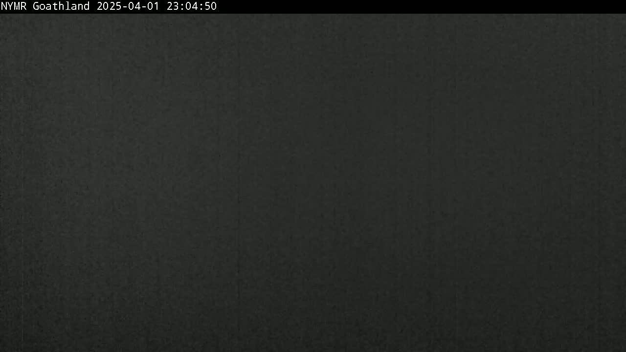 A dark, uniformly colored image shows a solid, dark-grey or black surface.