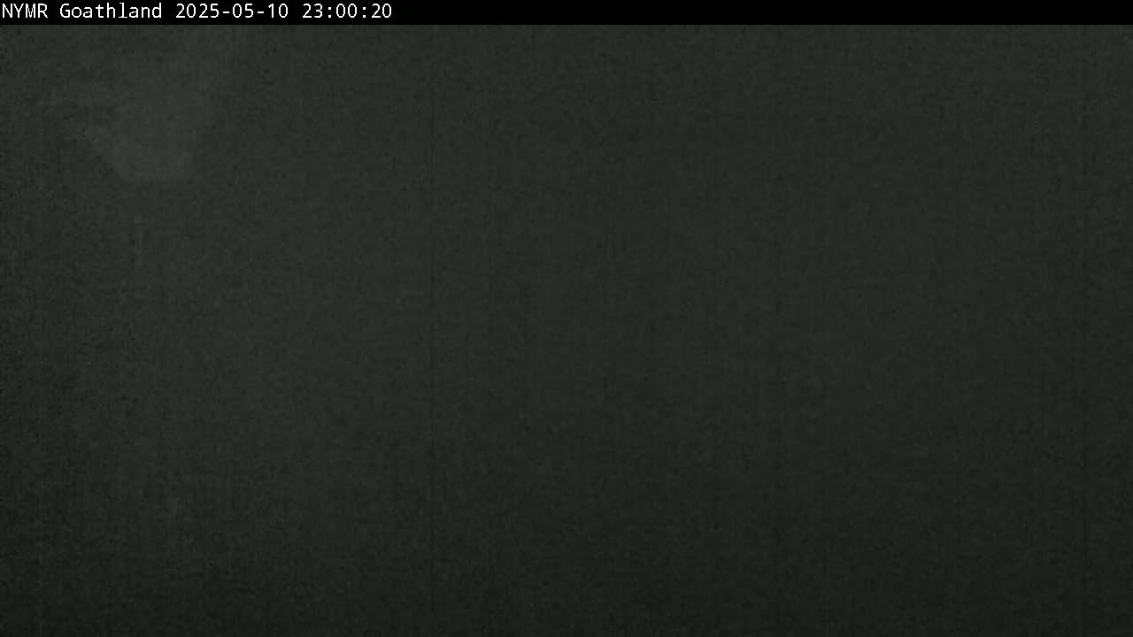 A dark, grainy image shows a mostly uniform, dark-grey surface at night.