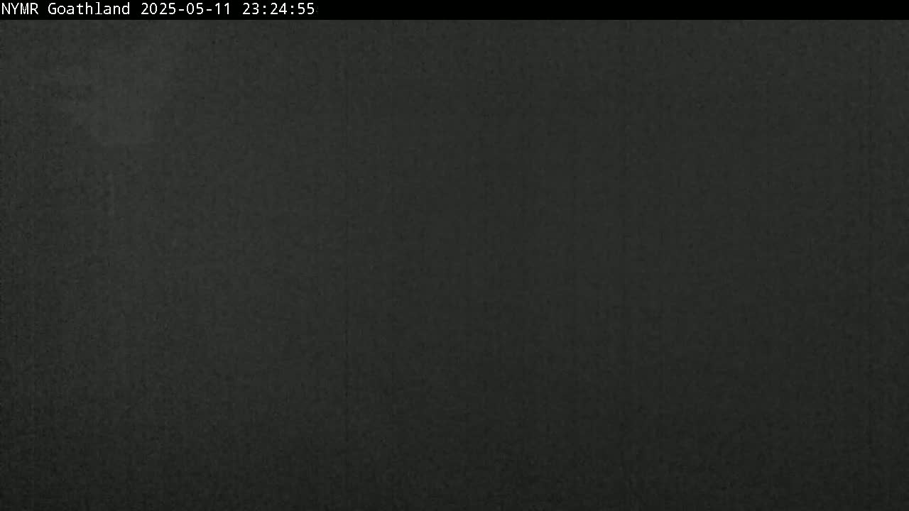 A dark, blurry image shows a mostly featureless night scene.