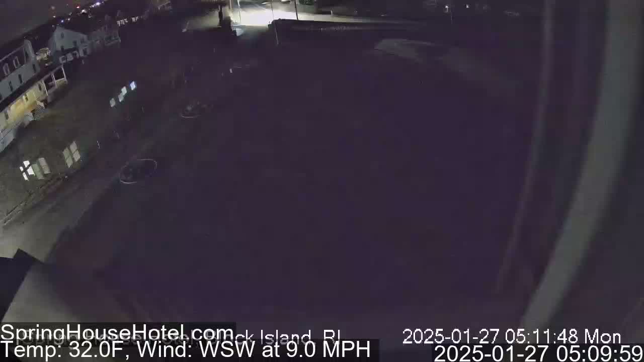 A nighttime, low-light view of a street and buildings, with a WSW wind blowing at 9.0 mph and a temperature of 32°F.