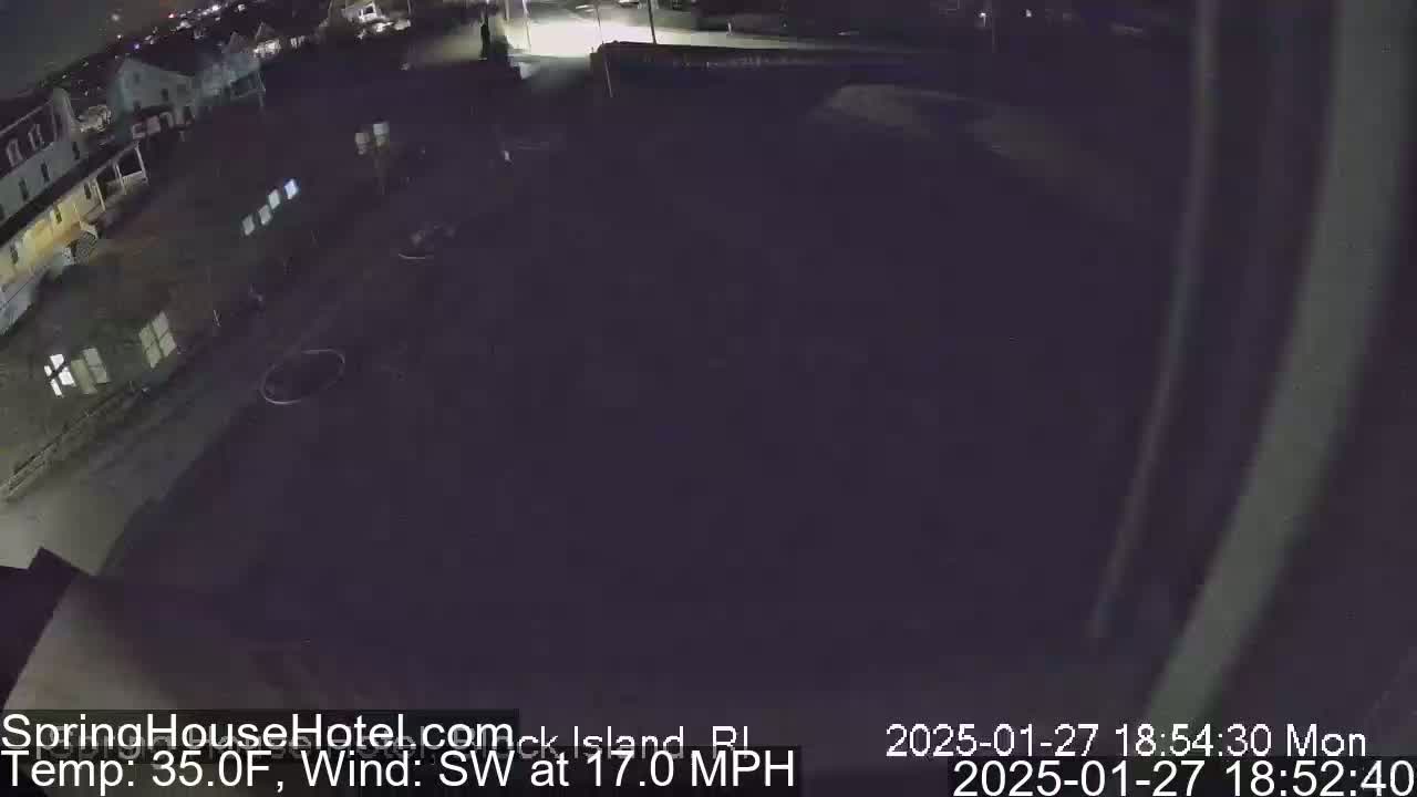 A nighttime, dark outdoor scene shows a section of a parking lot and buildings with a southwest wind at 17 mph and a temperature of 35°F.