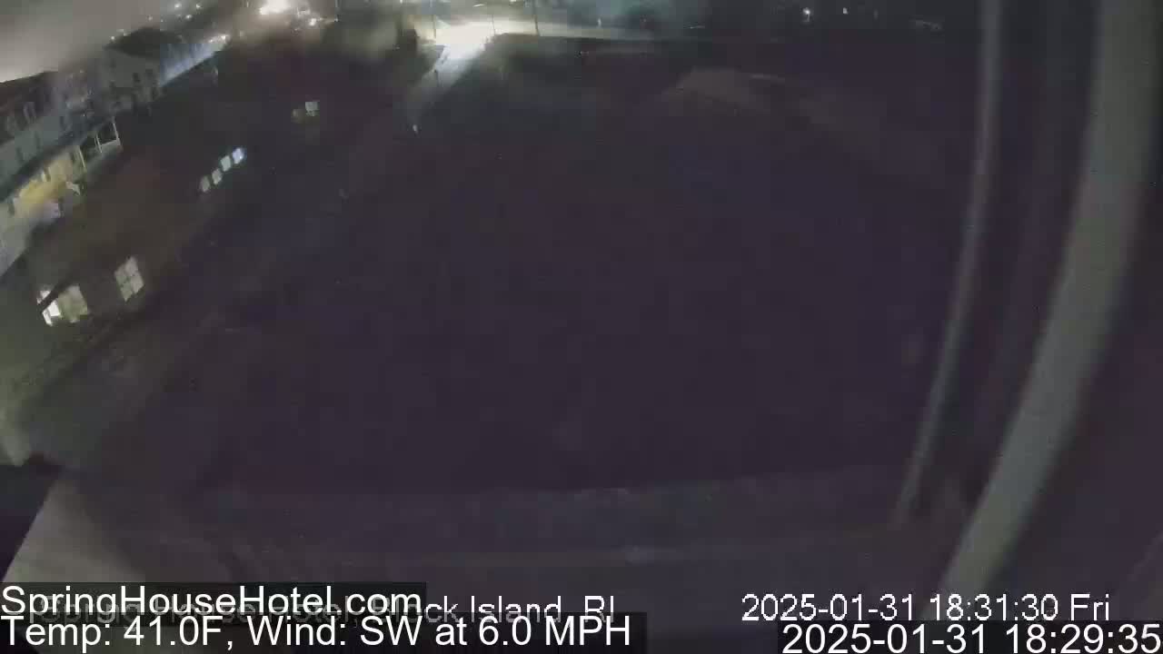 A nighttime, dark view of a street and buildings with a southwest wind at 6 mph and a temperature of 41°F.