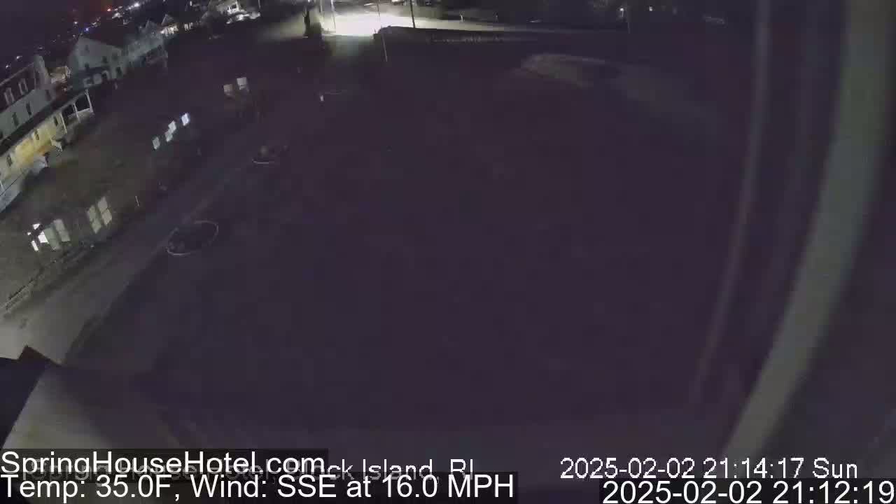 A nighttime, high-angle view of a dark parking lot and buildings with a 35°F temperature and a 16 mph wind from the SSE.