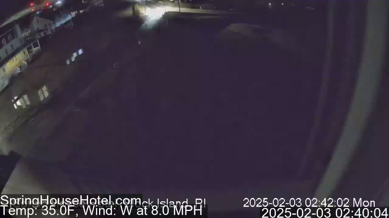 A nighttime, wide shot of a street and buildings with a westerly wind at 8 mph and a temperature of 35°F.
