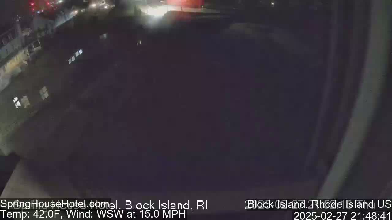 A nighttime, aerial view of a dark building and street with a WSW wind at 15 mph and a temperature of 42°F.