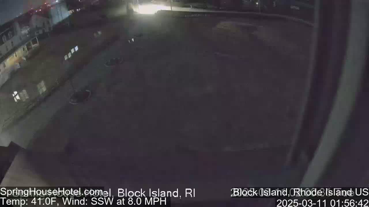 A nighttime, high-angle view of a dark parking lot next to a building under a clear sky with a south-southwesterly wind blowing at 8 mph and a temperature of 41°F.