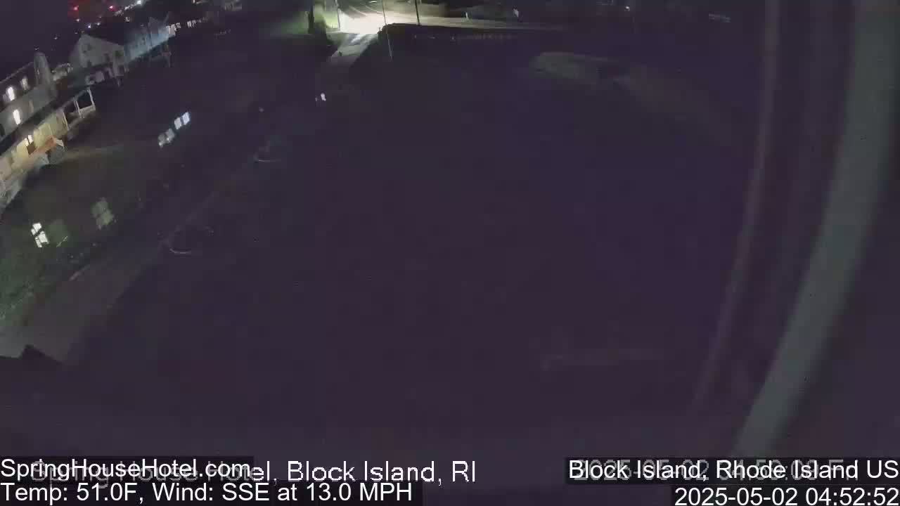A nighttime, high-angle view of a dark street and buildings with a 51°F temperature and a 13 mph wind from the SSE.