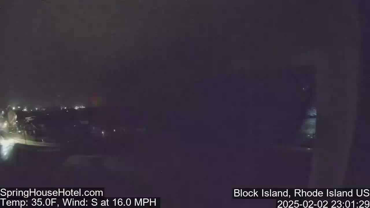 A nighttime, dimly lit view of a town, with a 35°F temperature and a 16 mph south wind.
