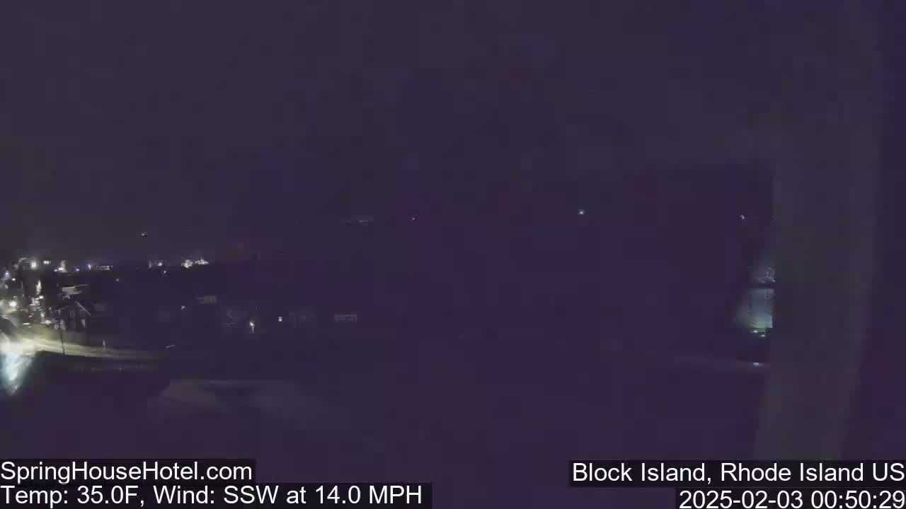A nighttime, dimly lit view of a town under a dark sky with a south-southwesterly wind at 14 mph and a temperature of 35°F.