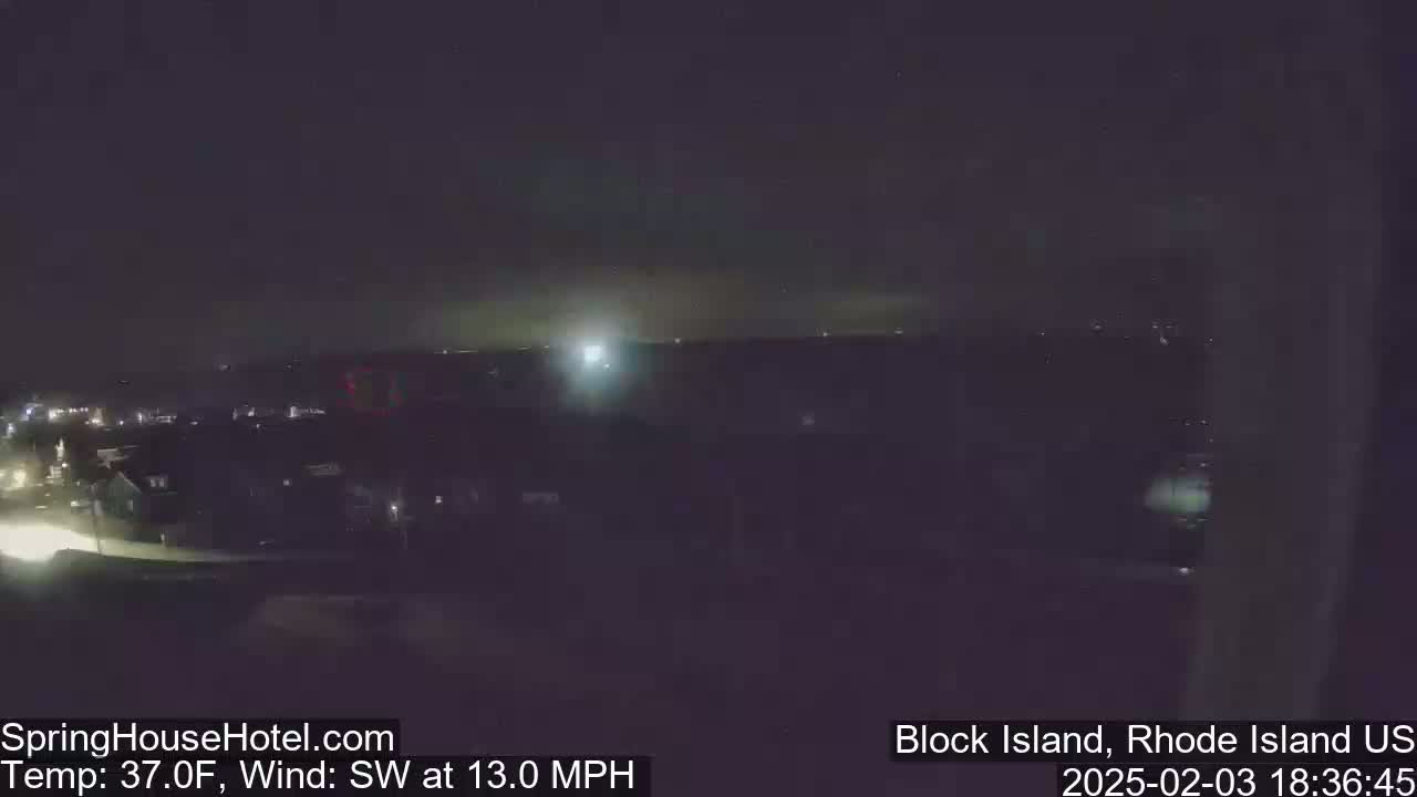 A nighttime view of a town under a dark sky with a southwest wind at 13 mph and a temperature of 37°F.