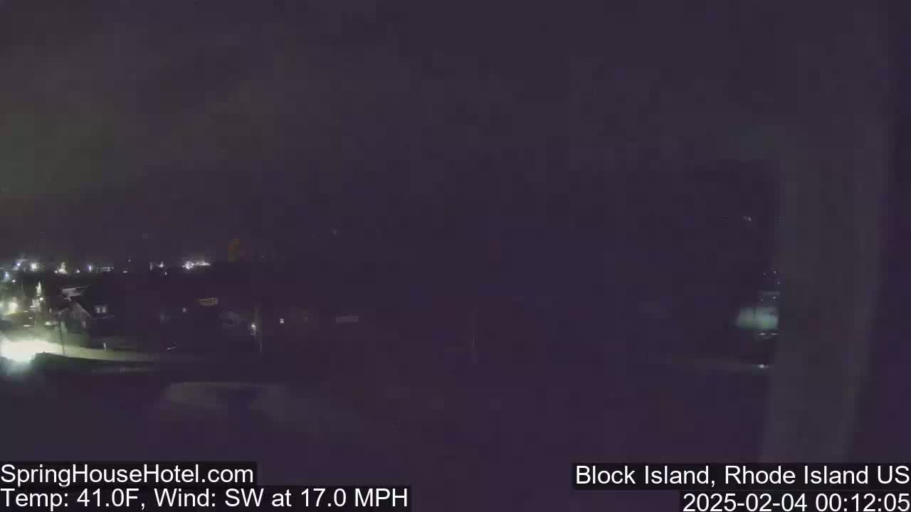 A nighttime, long shot of a dimly lit town with a southwest wind at 17 mph and a temperature of 41°F.