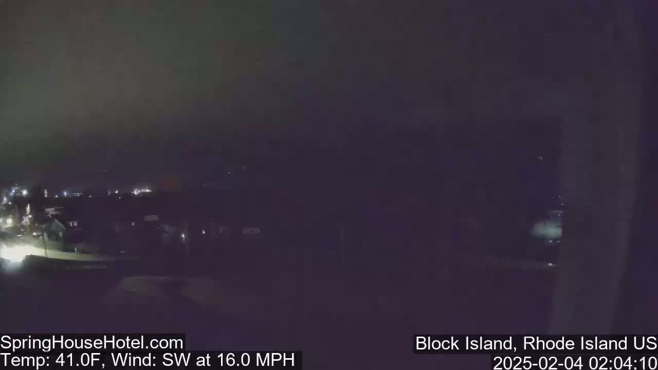 A nighttime view of a town with dim lights, under a dark sky, with a southwest wind blowing at 16 mph and a temperature of 41°F.