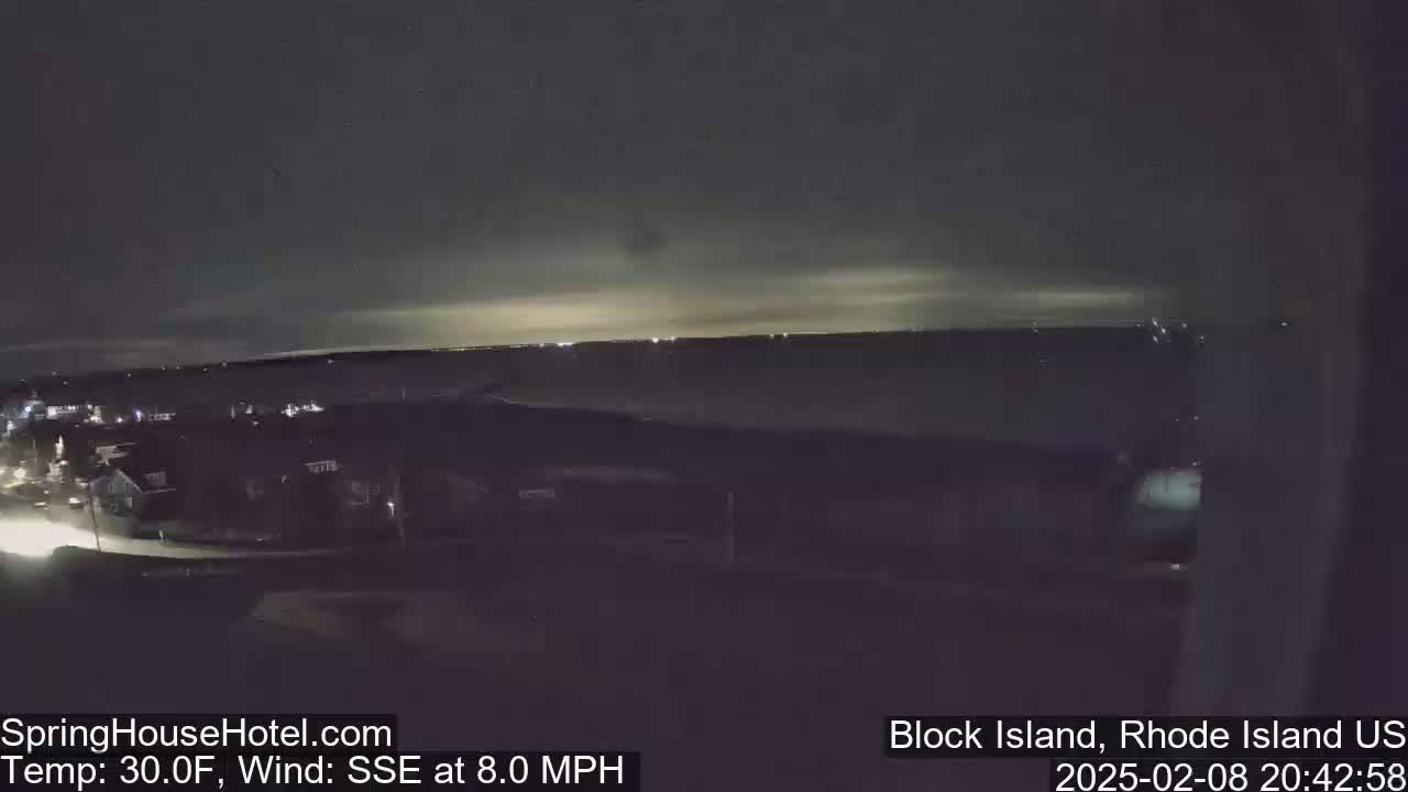 A nighttime, overhead view of a town under a mostly clear sky with an 8 mph wind from the south-southeast, and a temperature of 30°F.