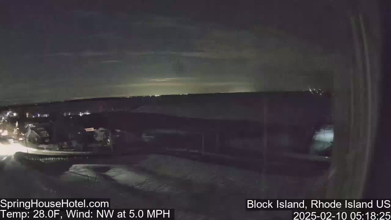 A nighttime, low-light view of a residential area with a northwest wind at 5.0 mph and a temperature of 28°F.