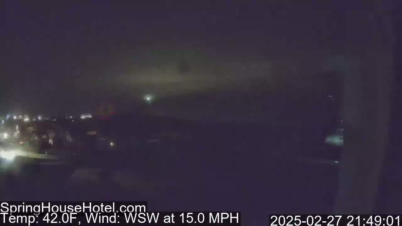 A nighttime view of a city skyline with a WSW wind at 15 mph and a temperature of 42°F.