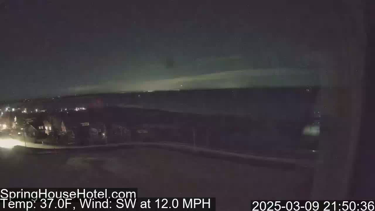A nighttime view of a suburban area under a mostly clear sky with a southwest wind at 12 mph and a temperature of 37 degrees Fahrenheit.