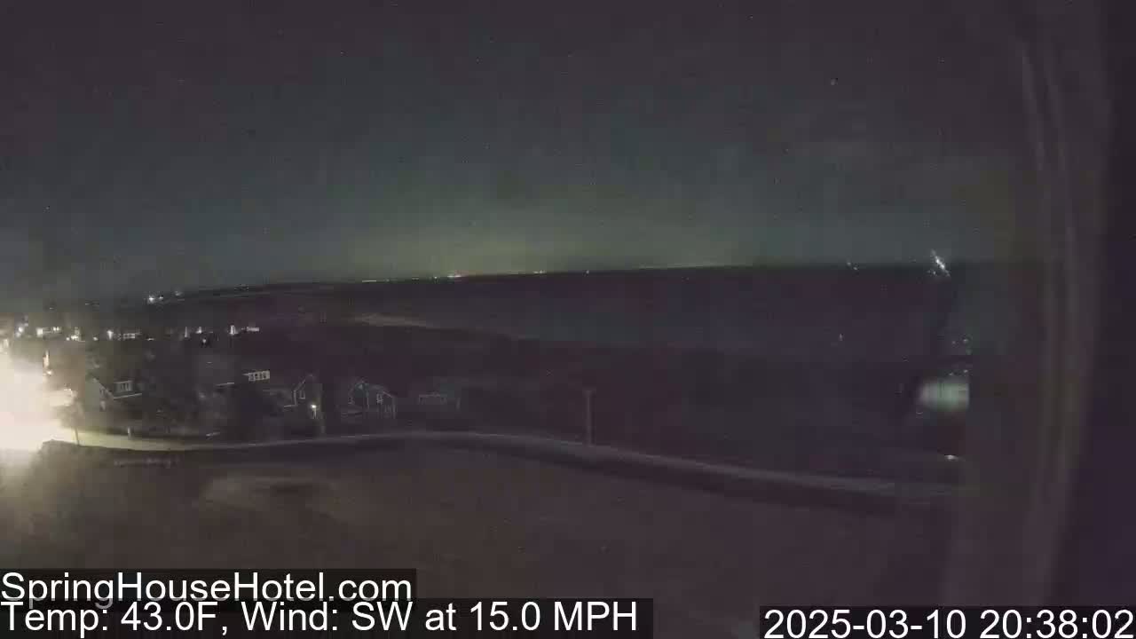 A nighttime, low-light view of a residential area with a southwest wind at 15 mph and a temperature of 43 degrees Fahrenheit.