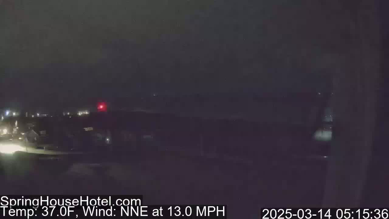 A nighttime, low-light view of a residential area with a 37°F temperature and a 13 mph wind from the north-northeast.