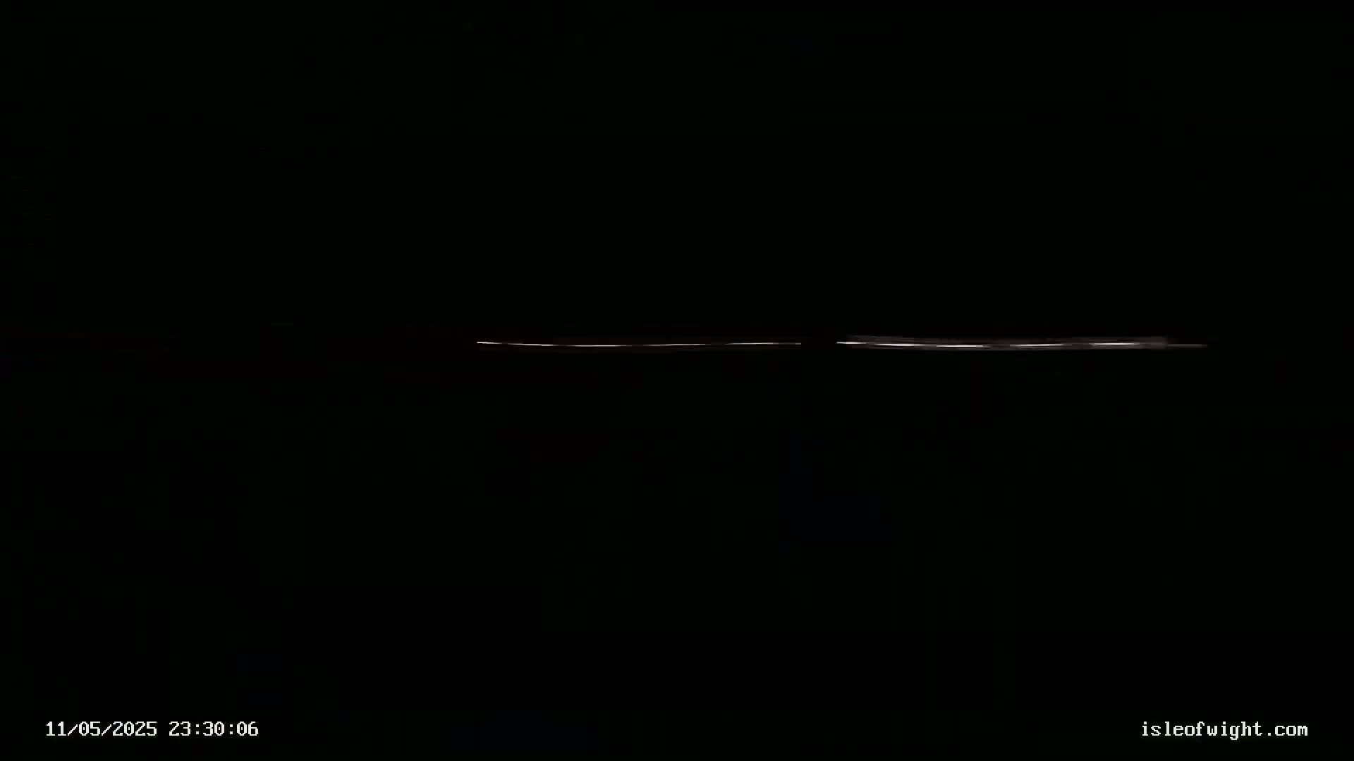 A low, thin, horizontal line of light is visible in the dark.