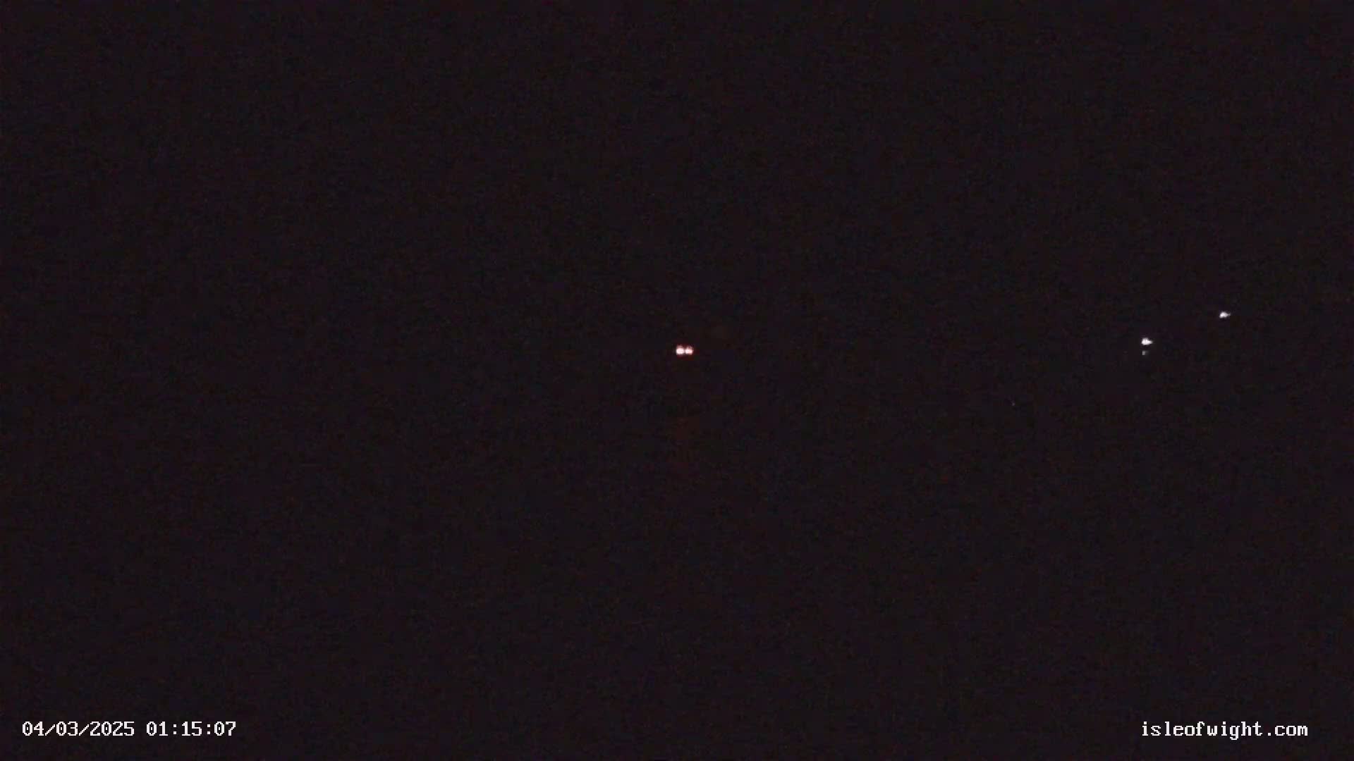 A dark night sky shows several small, distant lights.