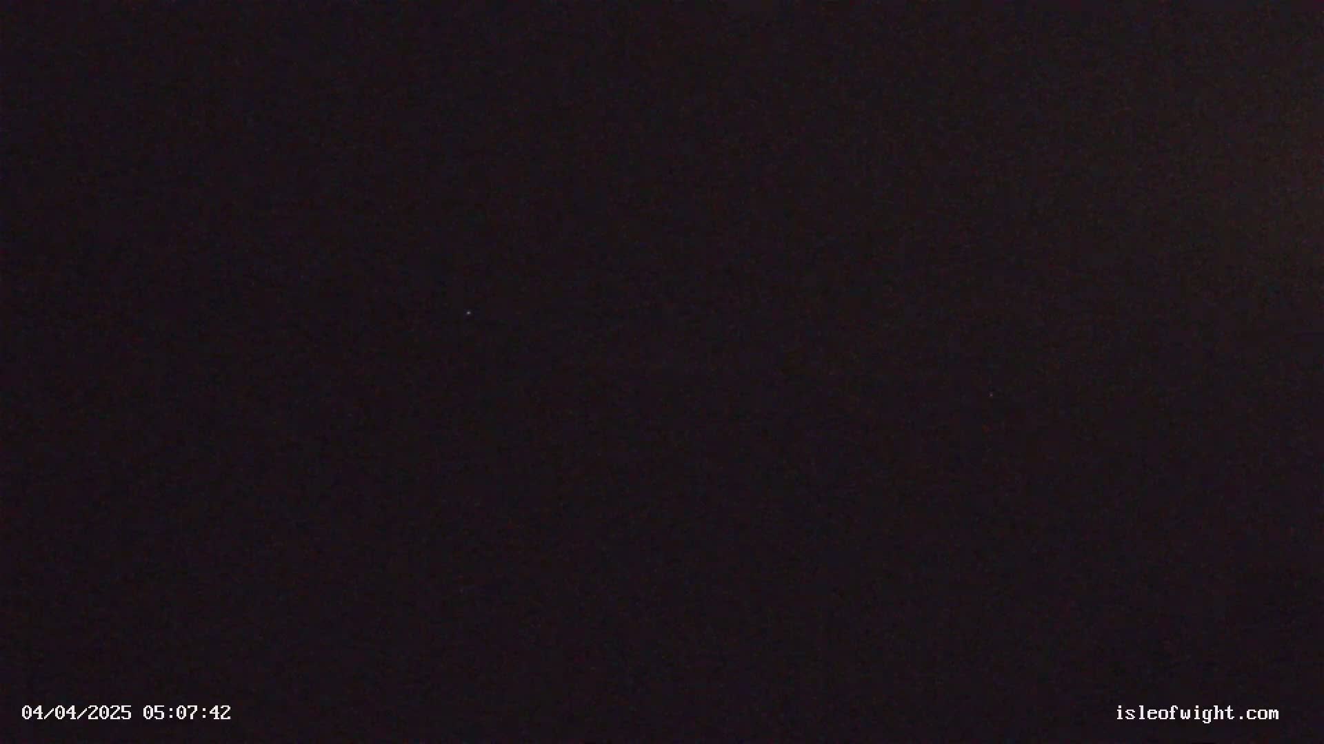 The image shows a completely dark, nighttime scene.