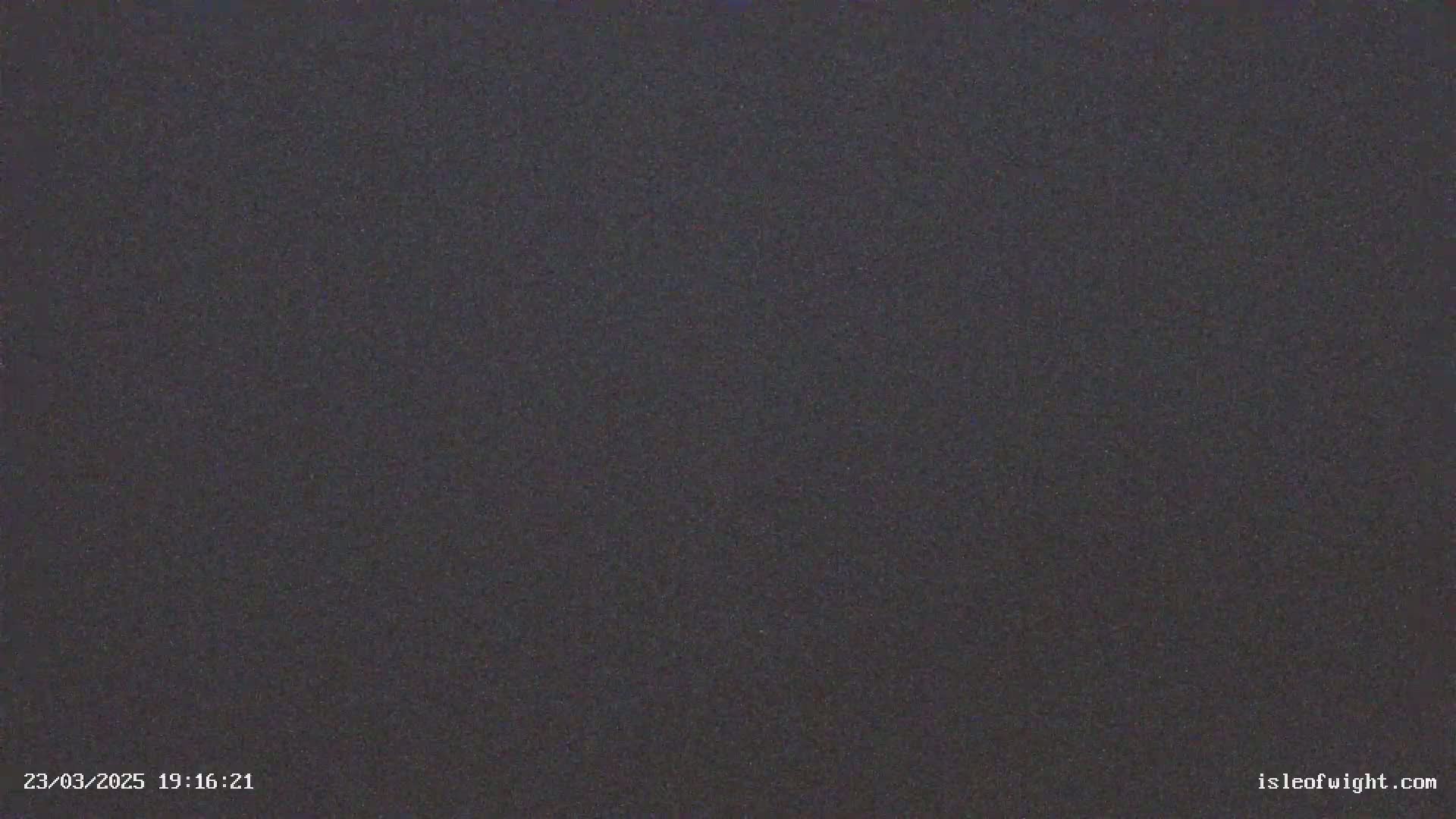 A dark, grainy image shows a completely uniform dark gray surface.