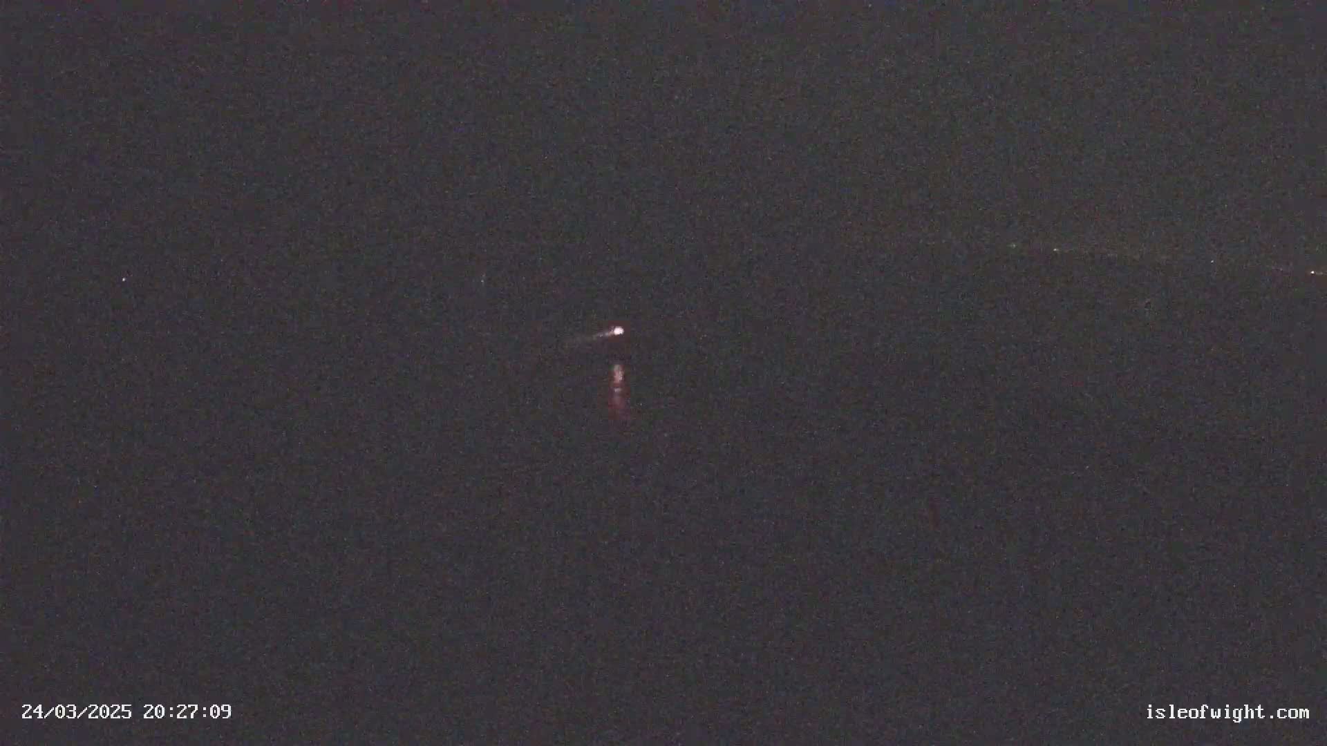 A small, faint light is visible in the dark night sky.