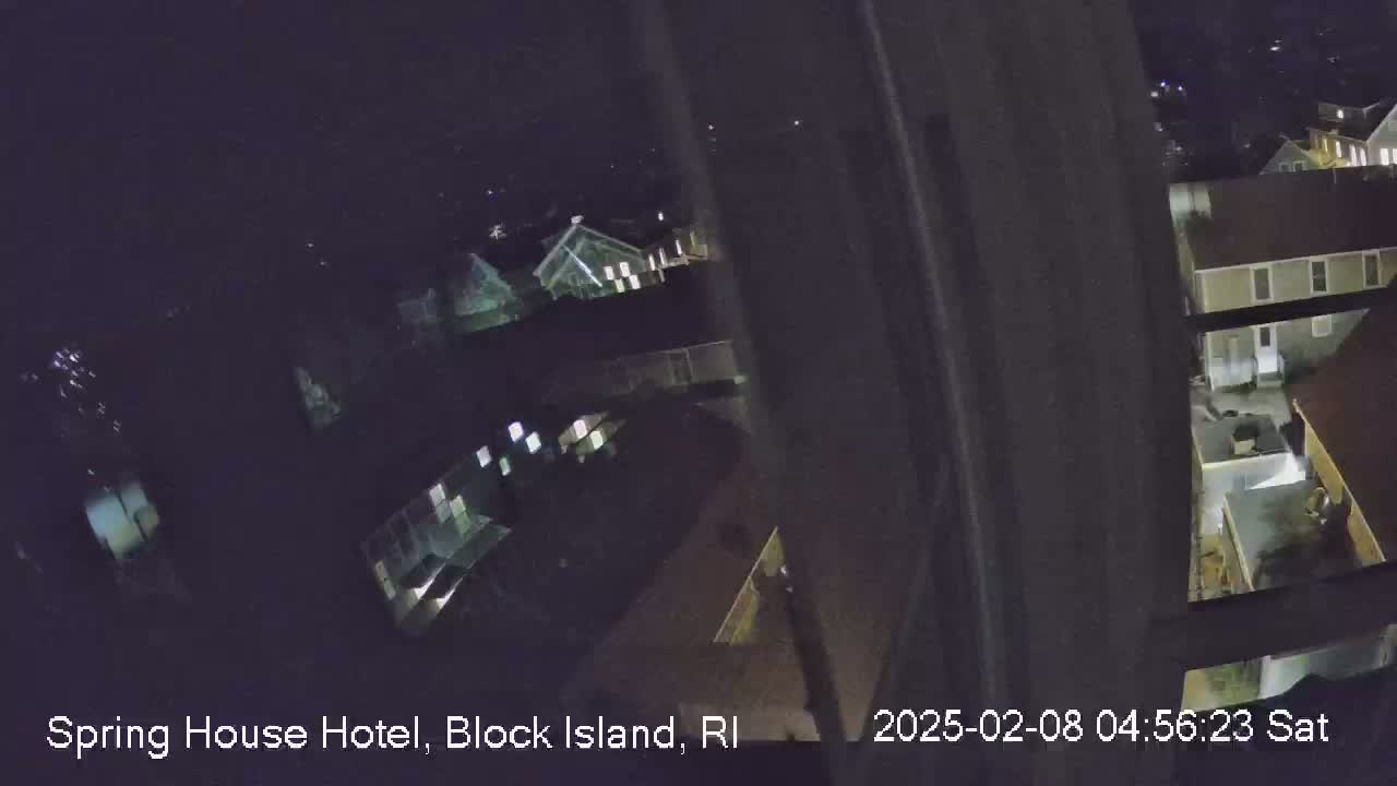 A nighttime, high-angle view of a building complex, showing several structures with illuminated windows.