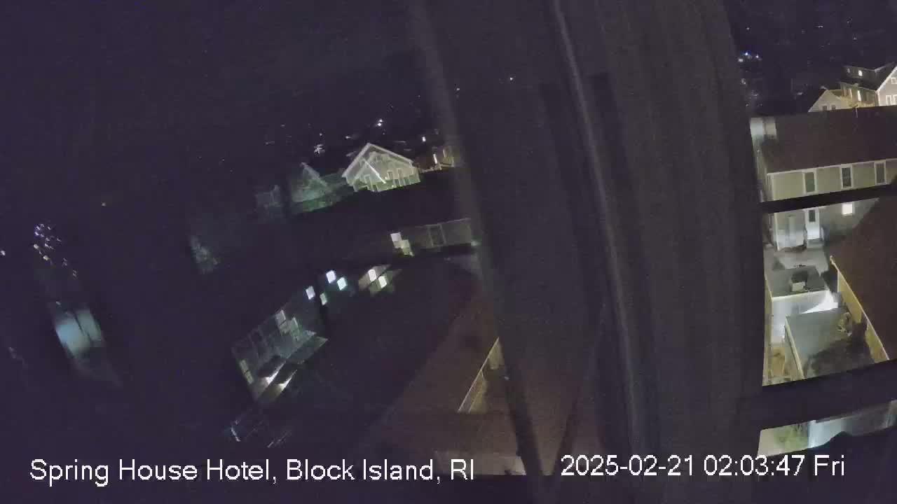 A nighttime, high-angle view shows several buildings illuminated by artificial light.