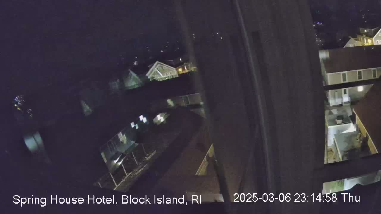 A nighttime, high-angle view shows several buildings illuminated by artificial light.