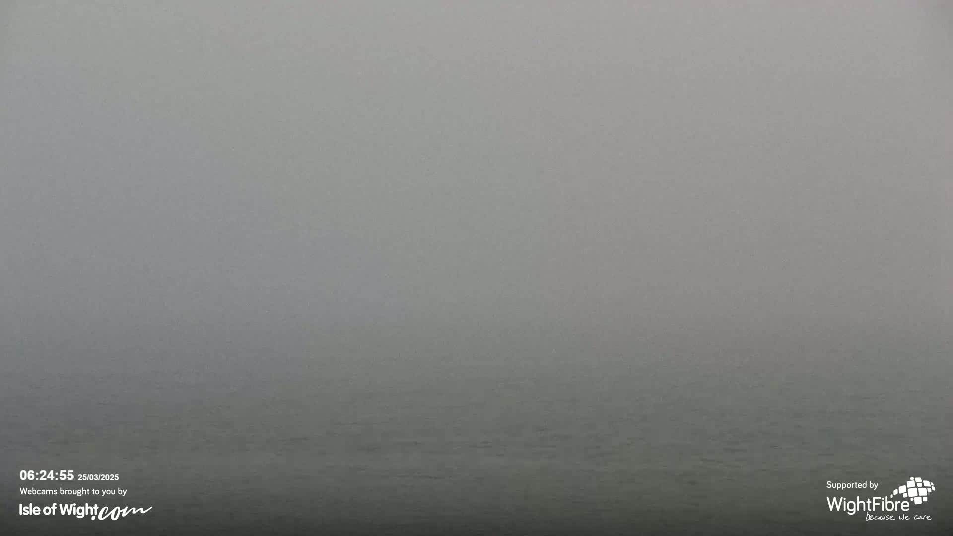 A body of water is visible under a thick fog.